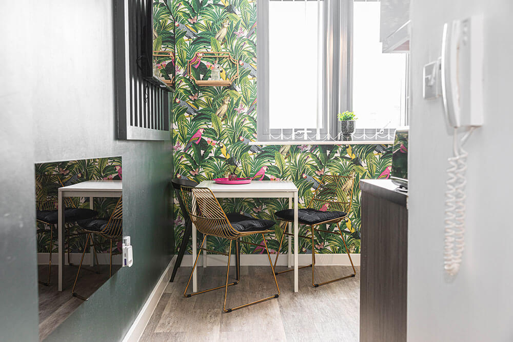 image of dining and lounge area in phoenix collection apartment showing a tv and sitting area